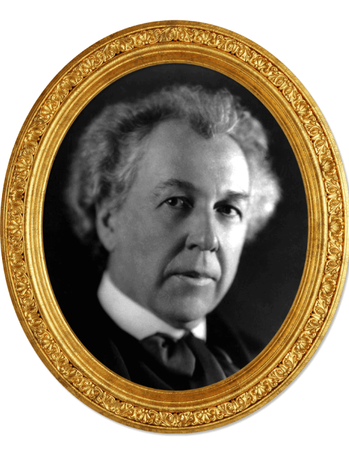 A black and white portrait of a distinguished man in an ornate gold oval frame, set against a black background.