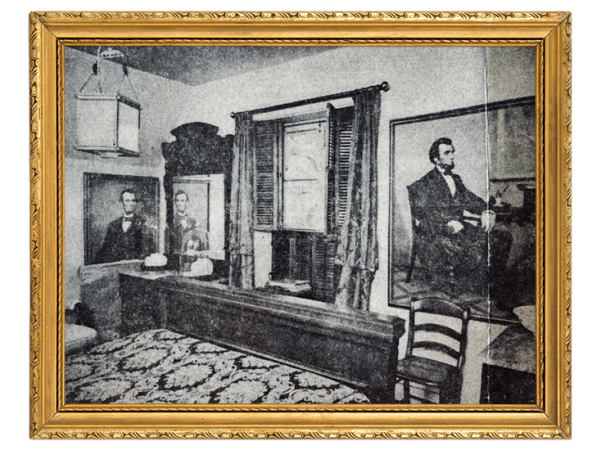 A vintage courtroom scene with three men: a judge at the bench, a clerk or counsel seated, and a speaker or witness standing to the side, in black-and-white.