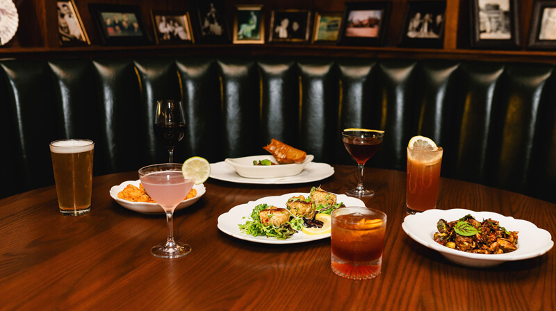 booth at Uphoff's Rotunda with various cocktails and shareable dishes