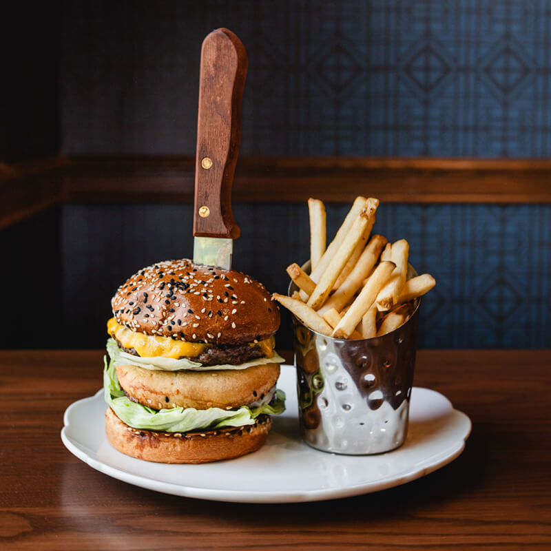 Gourmet cheeseburger with fries served at Dawn Manor